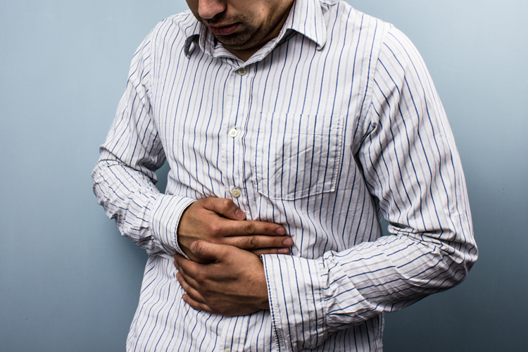 Sick Man Holding Stomach in Pain 